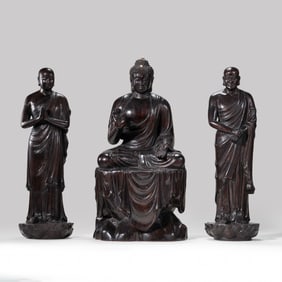 A RARE AND MAGNIFICENT GROUP OF THREE ZITAN WOOD FIGURESCOMPRISING SHAKYAMUNI BUDDHA AND TWO