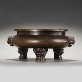 A RARE AND IMPRESSIVELY CAST BRONZE 'LION-MASK' TRIPOD CENSERMARK OF XUANDE, MING DYNASTY