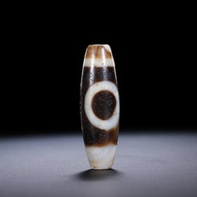 A RARE AND MAGNIFICENT 'SUN AND MOON' DZI BEADHIMALAYAN REGION, TIBET, ANCIENT TO MEDIEVAL PERIOD