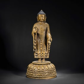 A MAGNIFICENT AND RARE GILT-COPPER FIGURE OF A STANDING BUDDHALHASA REGION, CENTRAL TIBET, 14TH -