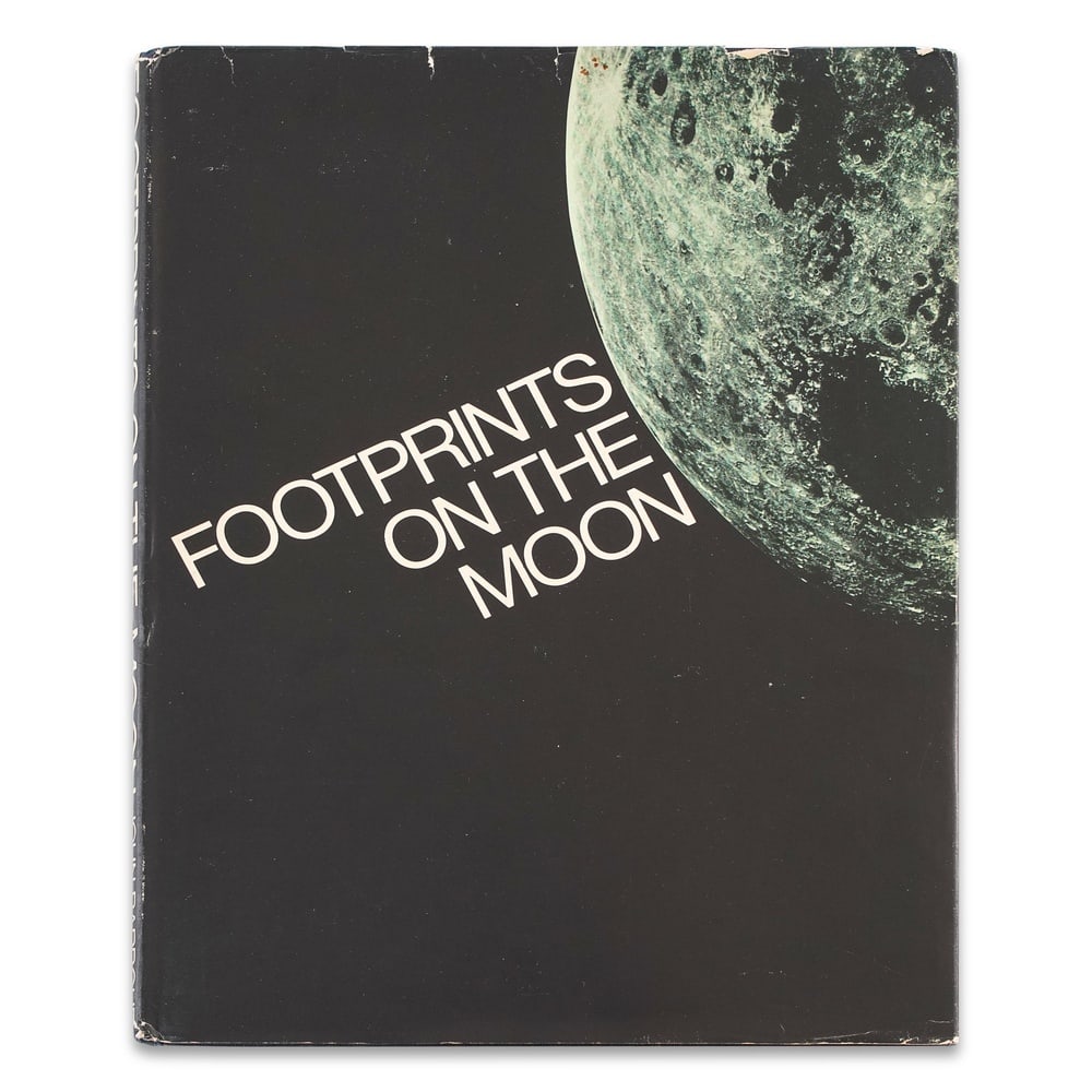 NEIL ARMSTRONG, BUZZ ALDRIN & MICHAEL COLLINS FULLY SIGNED "FOOTPRINTS ON THE MOON": 12 1/4 x 9 3/8 in (31 x 23.8 cm) Provenance and Authentication: This collectible has undergone a rigorous forensic evaluation. The signatures were carefully analyzed across multiple criteria,