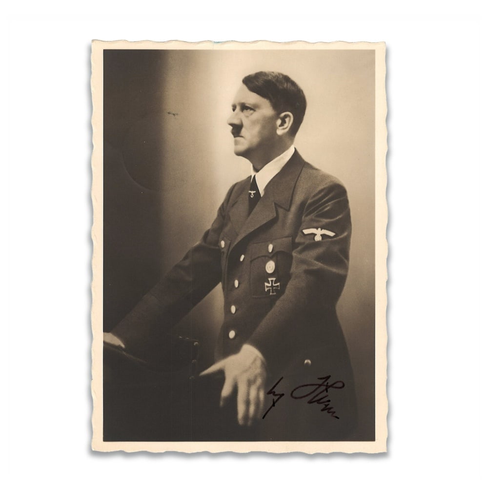 ADOLF HITLER SIGNED PHOTOGRAPHIC POSTCARD: 5 1/2 x 3 7/8 in (14 x 10 cm) Adolf Hitler remains one of the most consequential and controversial political figures of the twentieth century, whose role in shaping the course of World War II and