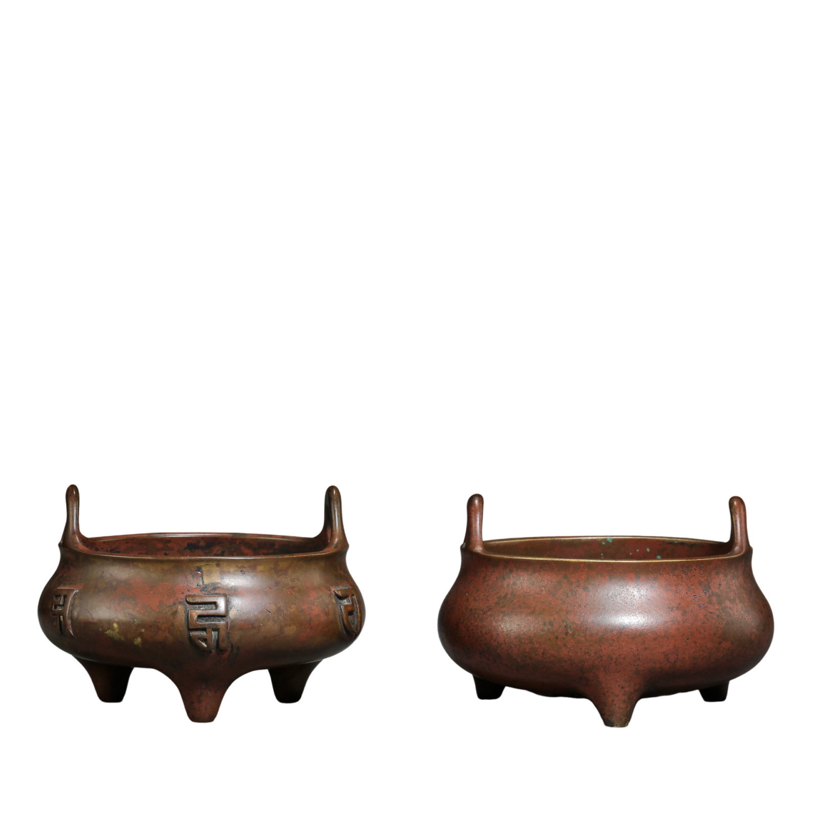 A Fine Group of Two Bronze Upright-Handled Tripod Incense BurnersXuande Period, Ming Dynasty: Dimensions & Weight Longevity Character Burner: Length 11.5 cm (4.53 in), Height 7.8 cm (3.07 in), Weight 588 g; 15th Century.Plain Burner: Length 11.5 cm (4.53 in), Height 7.5 cm (2.95 in), Weight 80