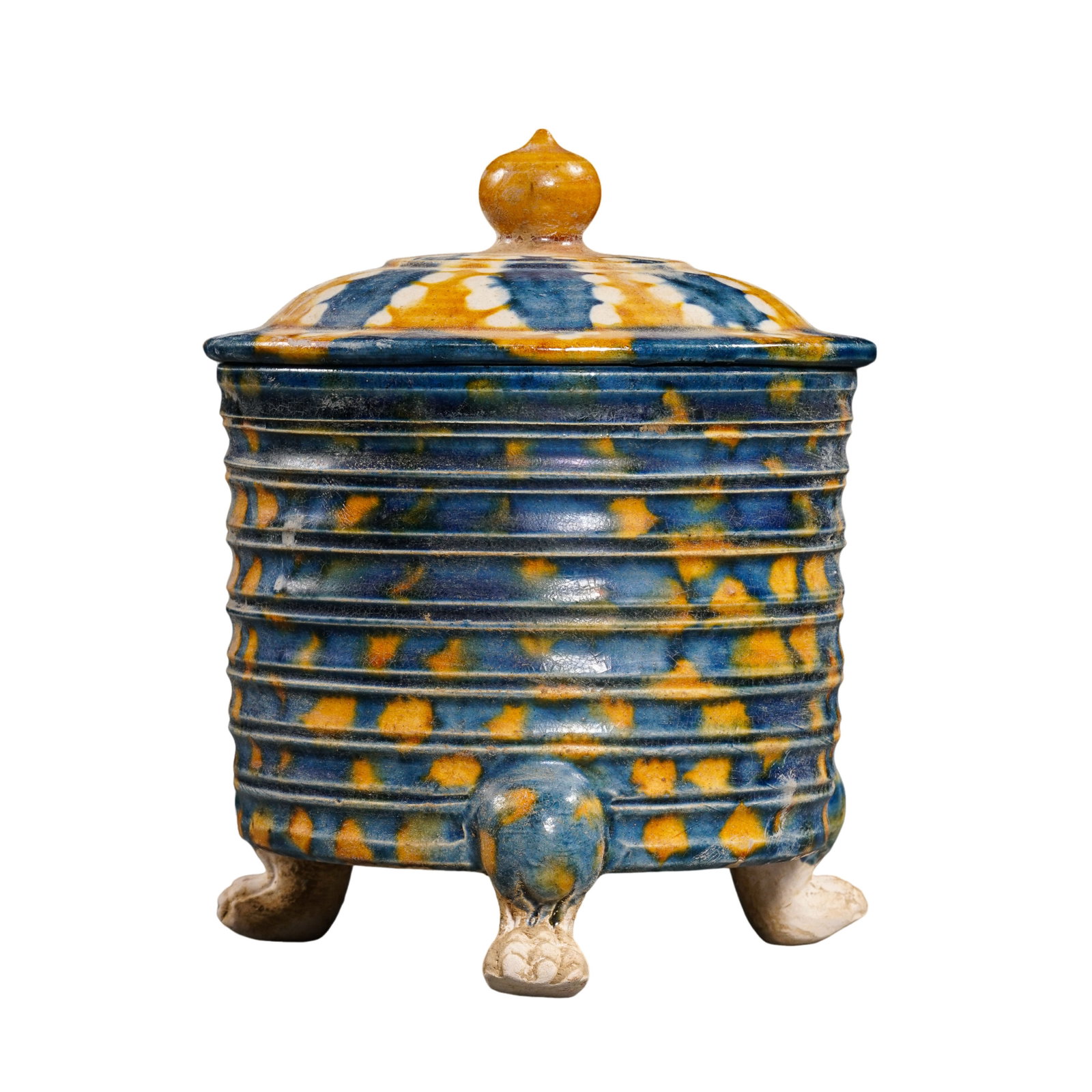 Tang Dynasty Sancai Glazed Covered Tripod Censer with Hanging-Basket Pattern (7th–9th Century): Dimensions: 7th–9th Century; Height: 11 cm (4.33 in.)Condition & Provenance: In good overall condition with its original cover intact. The tripod feet remain stable and complete. The vessel is decor