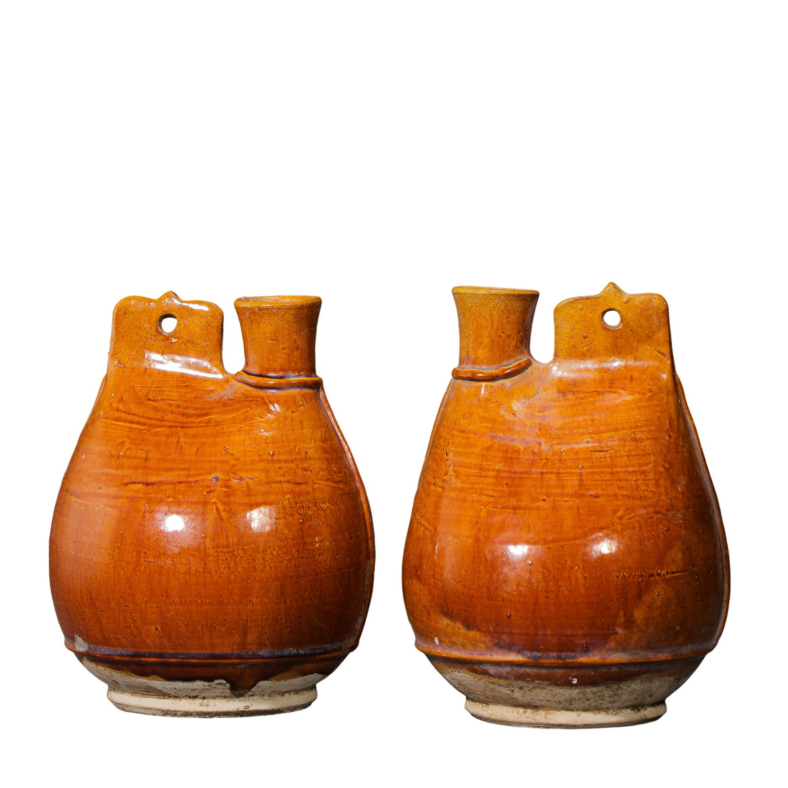 Pair of Liao Dynasty Yellow-Glazed Leather-Shaped Ewers (10th–12th Century): Dimensions: 22 cm high × 17 cm wide (10th–12th century, Liao Dynasty), approximately 8.7 inches high × 6.7 inches wideCondition & Provenance: Good overall condition with well-preserved glaze. The 