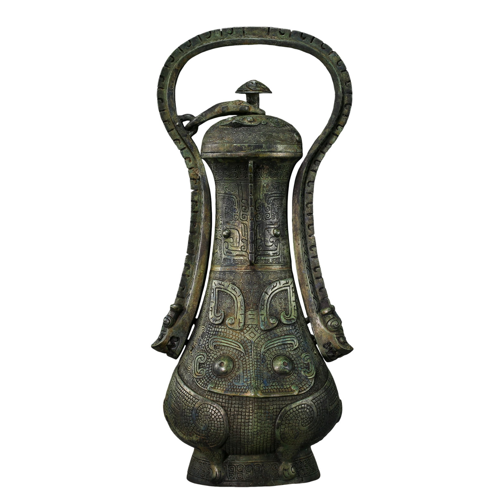 Shang to Zhou Dynasty Bronze Covered Ewer with Animal Mask Decoration and Loop Handle (Approx.: Dimensions & Weight: Height 37 cm (14.6 in / 1.21 ft), width 16 cm (6.3 in / 0.52 ft), weight 3,308 g, Shang to Zhou Dynasty period (Approx. 16th–3rd Century BCE)Condition & Provenance: The vessel i