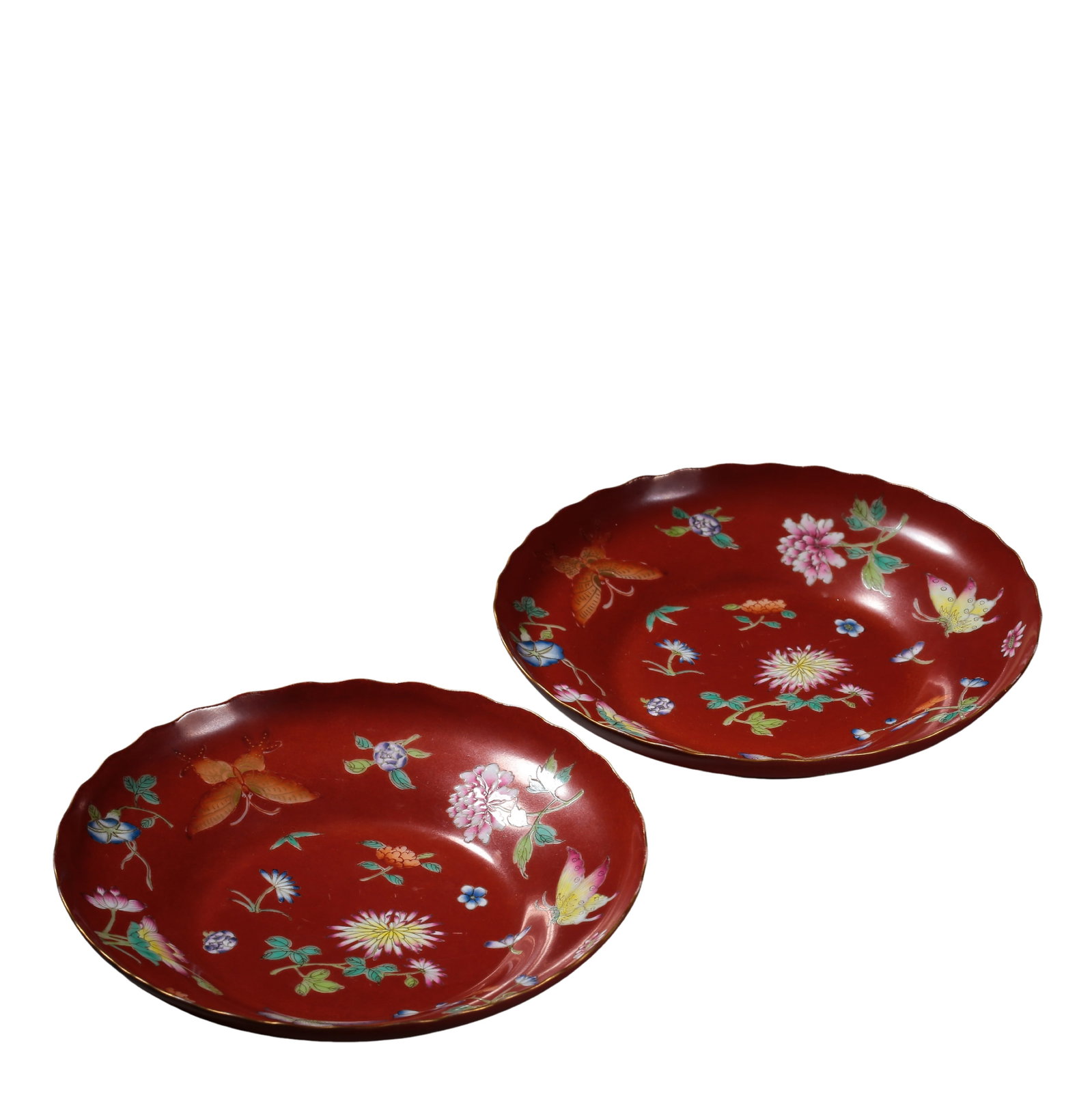 A Pair of Jiaqing Period Coral Red Ground Famille Rose Floral and Butterfly Motif Flower-Shaped: Dimensions: Diameter 13.5 cm (5.3 in, 0.44 ft), Height 2.8 cm (1.1 in, 0.09 ft); Qing Dynasty, Jiaqing Period (19th Century)Condition and Provenance: Good overall condition. The pair remains well pres