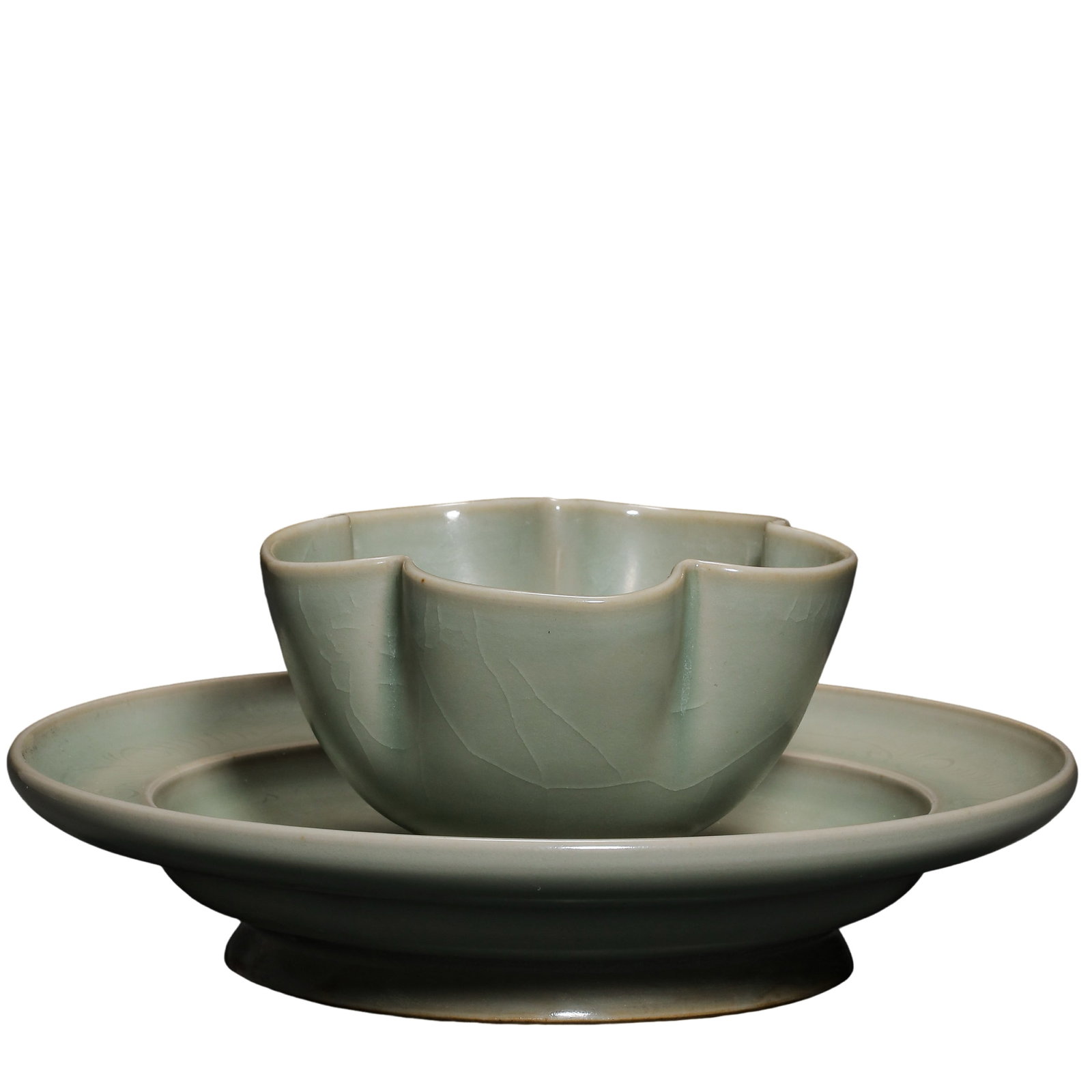 A Fine Longquan Celadon “Flower-Shaped Cup and Stand?? Set, Southern Song Dynasty (12th–13th: Dimensions: Cup height approximately 6.5 cm (2.56 in); Stand diameter approximately 16 cm (6.30 in); 12th–13th century Southern Song period Longquan celadon tea ware Condition and Provenance: Good o