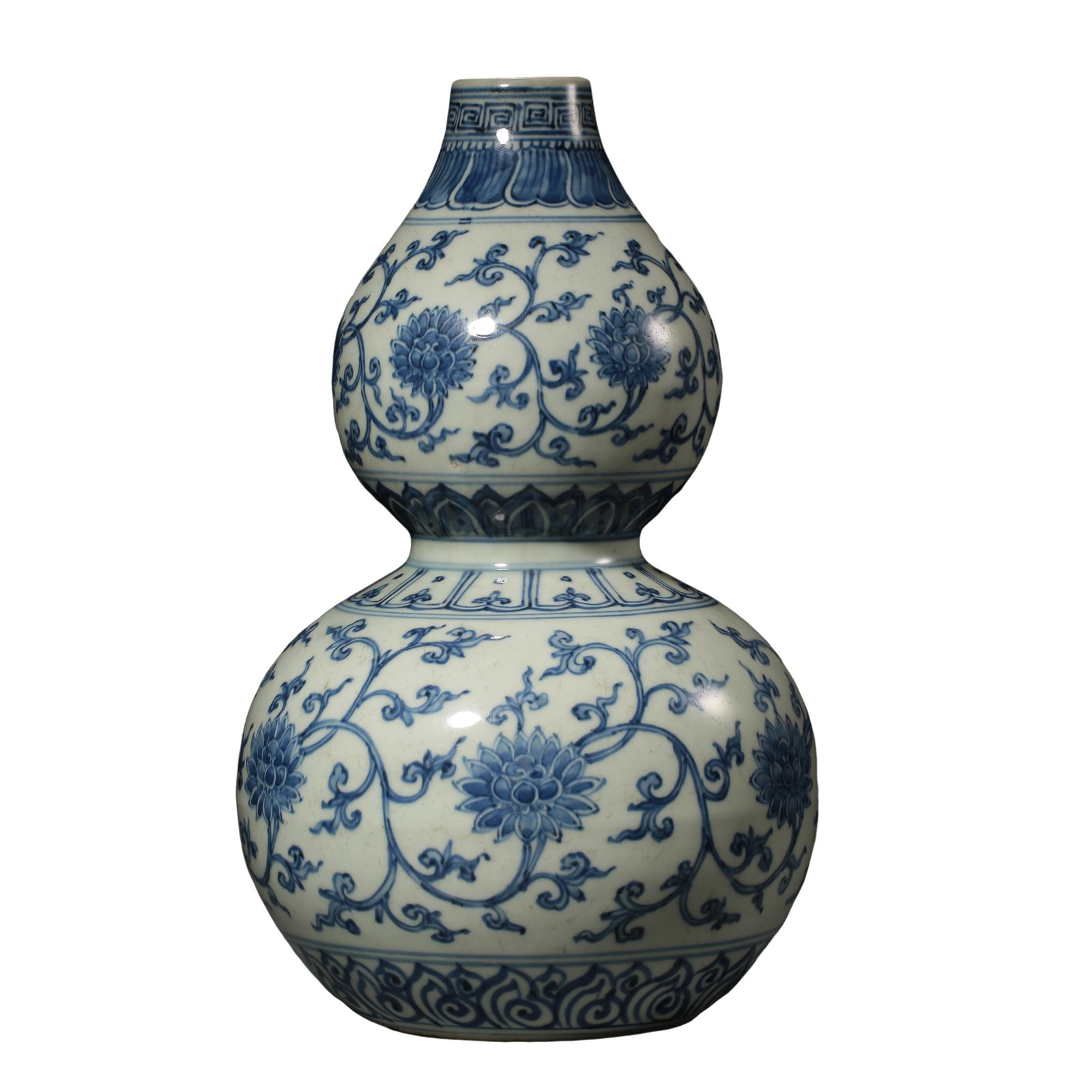 Yongle Period, Ming Dynasty Blue and White Double-Gourd Vase with Continuous Lotus Scroll Decoration: Dimensions: H. 31 cm (12.2 in / 1.02 ft); Mouth Dia. 4.5 cm (1.8 in); Ming Dynasty, Yongle Period, 15th Century?Condition & Provenance: The vase is preserved in good overall condition with a complete 