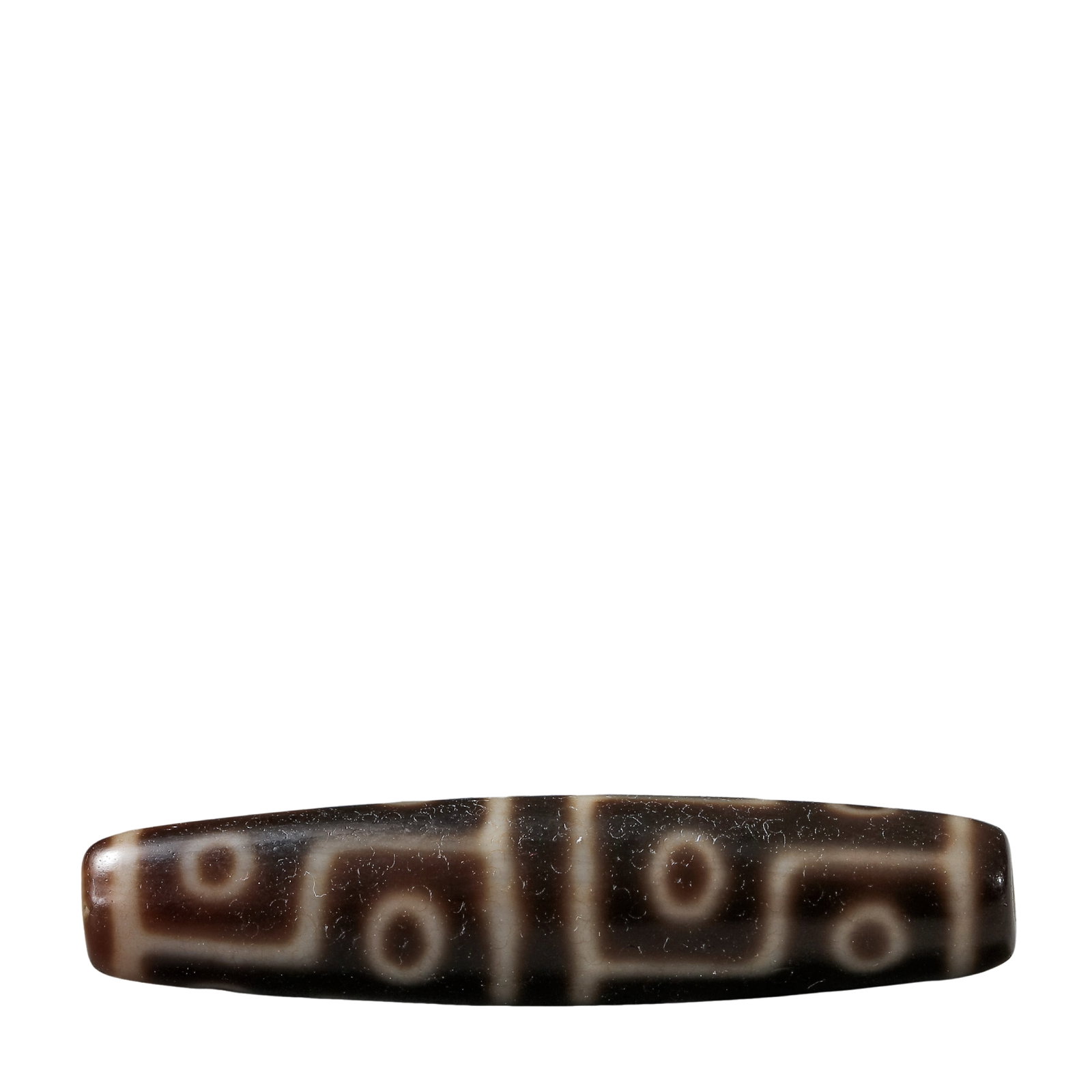 Eight-Eye Dzi Bead, 7th–10th Century CE (Tang Dynasty to Tibetan Empire Period): Dimensions & Weight: L. 5.6 cm / 2.20 in; Weight: 14 g; 7th–10th Century CE (Tang Dynasty to Tibetan Empire Period)Condition & Provenance: The bead is preserved in very good condition, with the orig