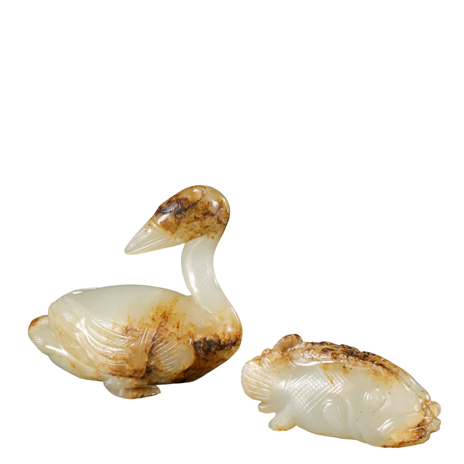 Ming–Qing Dynasty Hetian White Jade Goose and Mandarin Fish Carvings, A Pair: Dimensions: Ming–Qing Dynasty (17th–18th century). Jade goose: Length 4.5 cm / 1.8 in; Height 4 cm / 1.6 in. Jade mandarin fish: Length 3.8 cm / 1.5 in. Total weight: 45 g?Material: Hetian white j