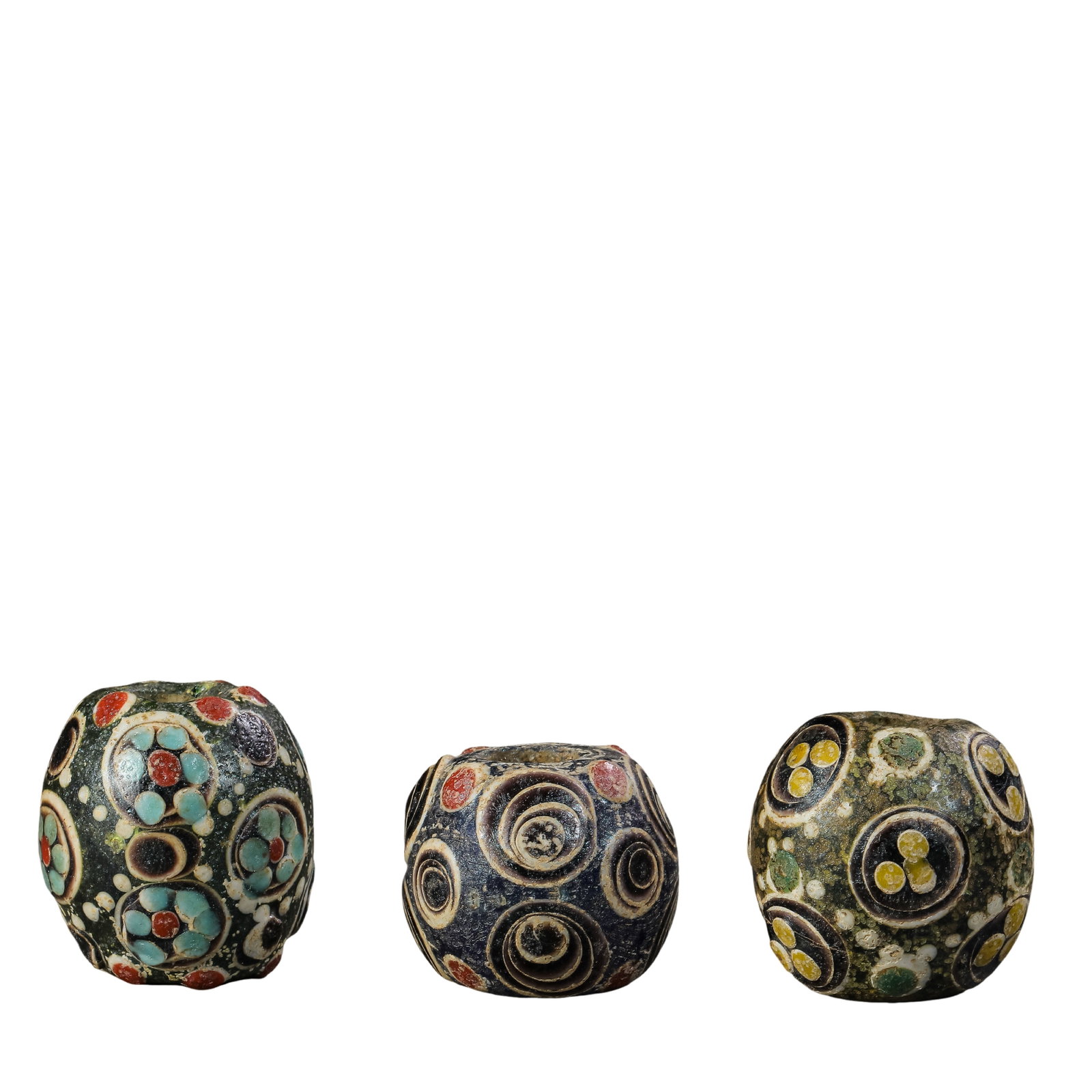 A Set of Three Warring States Period Millefiori “Eye Beads?? (5th–3rd Century BCE): Dimensions: Heights: 2.8 cm, 2.3 cm, and 2.7 cm (approx. 1.10 in, 0.91 in, and 1.06 in); Total weight: 81 g (approx. 2.86 oz)?Condition & Provenance: Well preserved overall. Each bead displays natural