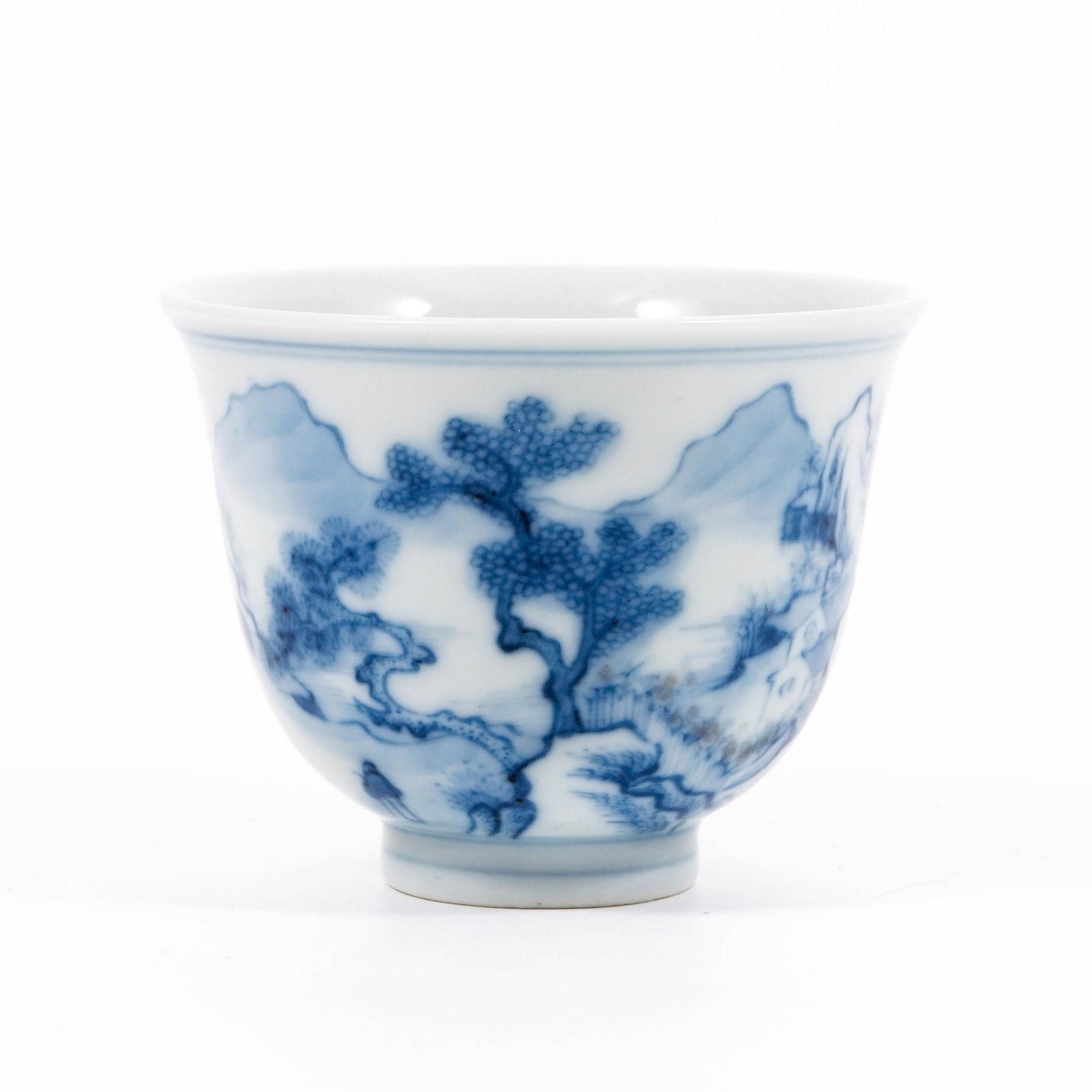 A BLUE AND WHITE CUP WITH A LANDSCAPE PATTERN (1 of 6)