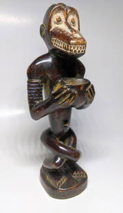 A Fine Cameroon Baboon Figure: Antique, deep-colored surface, cross-legged, a little beauty with the remains of its original lime powder. 9.75" Height