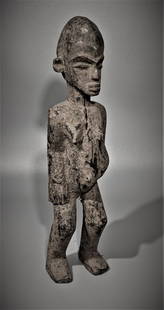 A Small Ancient Senufo ot Lobi Female: Legitimate encrustation, ancient crack lines. Dense and heavy wood. 11" tall. From The Museum of African Arts, Clinton, Mass., of which those offered here have never previously been shown or offered.