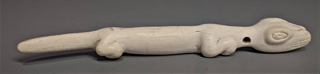 Elegant Taino Bone Carved Lizard Vomic: A very fine pure white bone carving of a lizard, its gender as human male, the slender and elongated form and tail to facilitate its purpose and with an amusing rack of teeth., Bow drilled from both