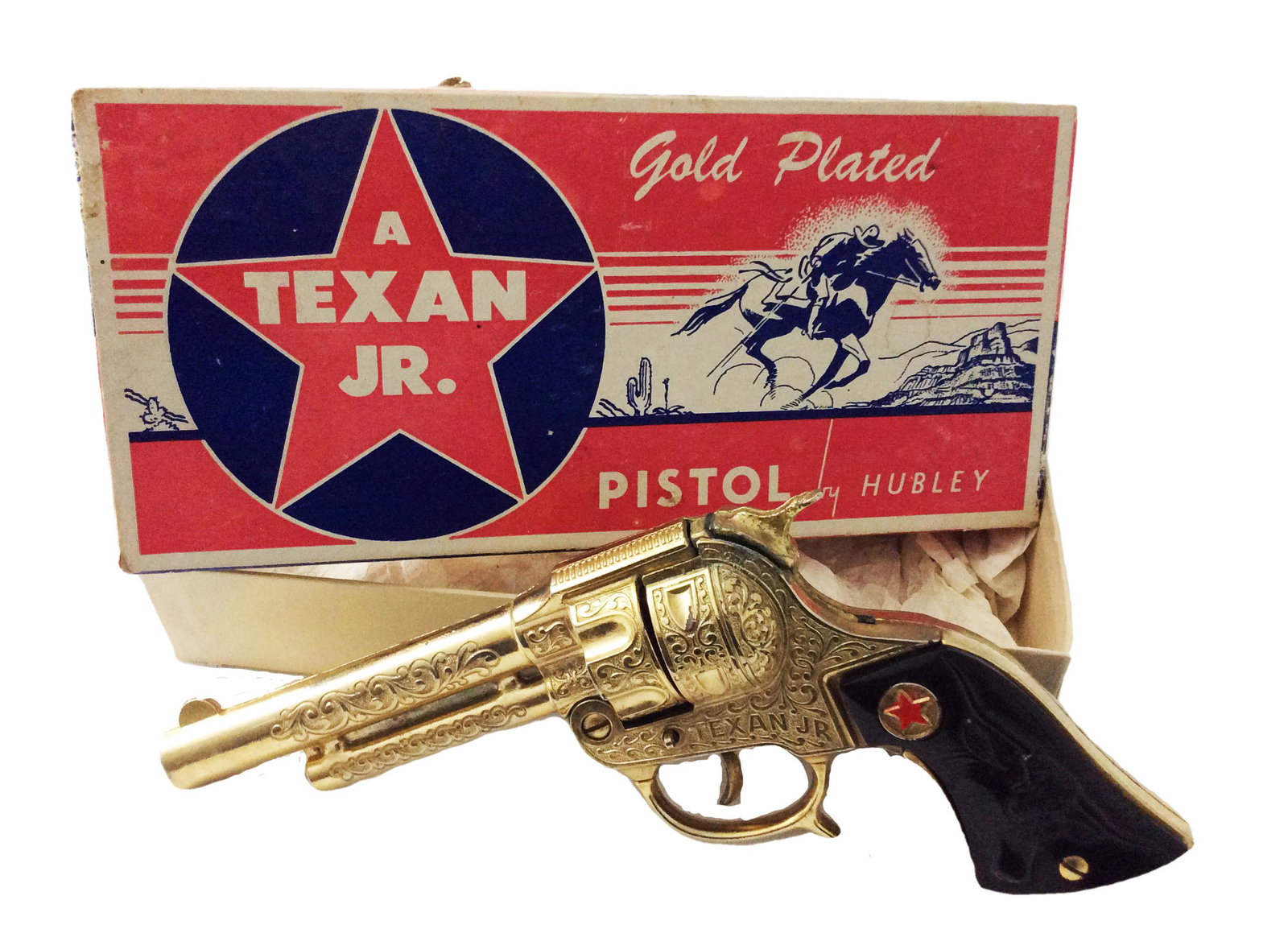 Hubley Texan Jr. Gold-Plated Cap Gun: Title: Vintage Texan Jr. Gold-Plated Cap Gun Maker: Hubley Materials: Gun is gold-plated Dimensions: 9"L Description: Vintage Hubley Texan Jr. gold-plated cap gun in the original box. Wear commensurat