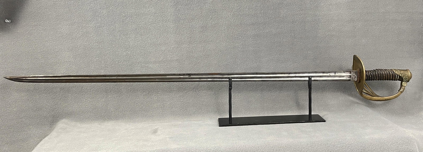Belgium Infantry Officers Sword: Country of Origin: Belgium Belgium Infantry Officers sword with decorative relief to the pierced brass guard and wooden handle with banding. Patina/surface wear commensurate with age and use including