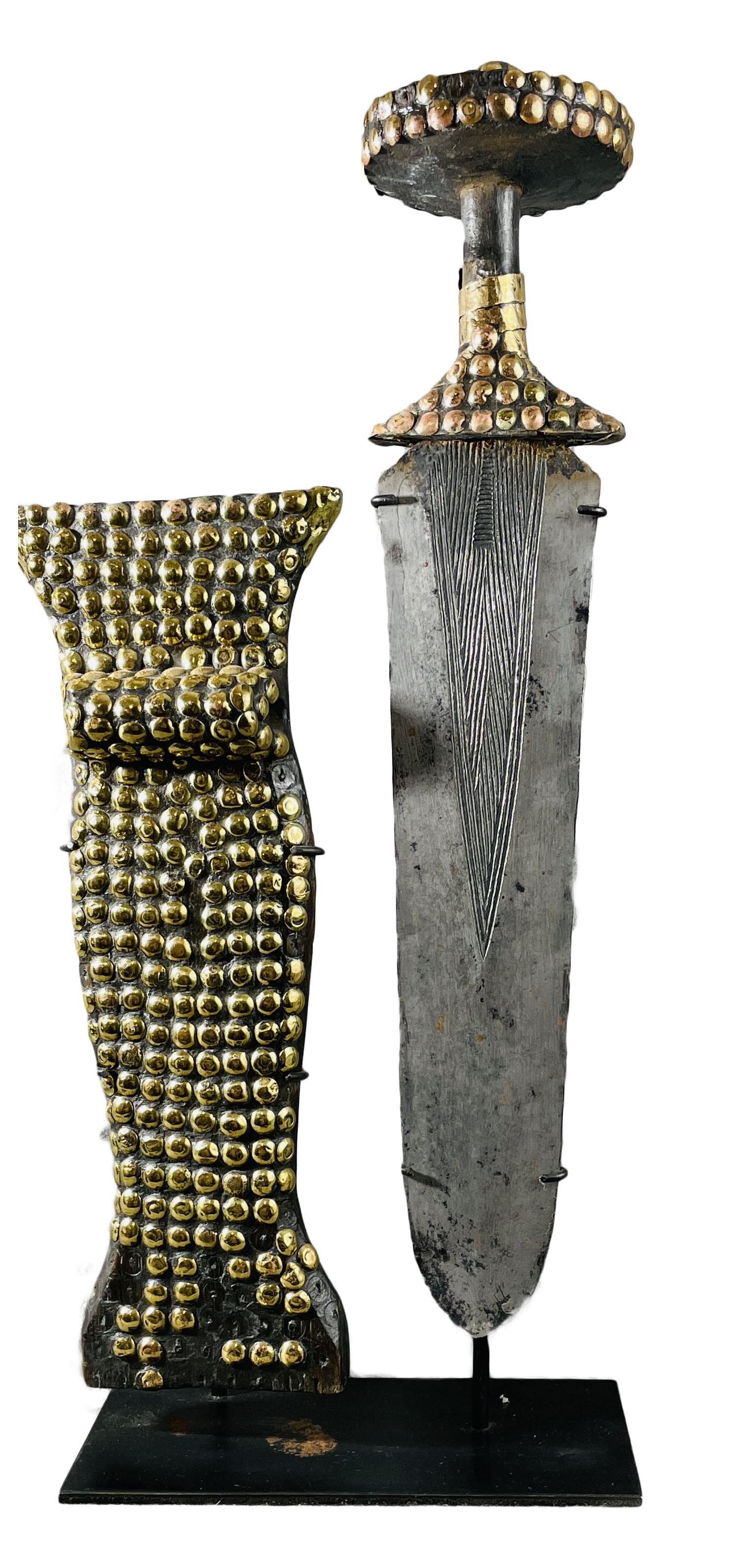African Congo Court Sword & Scabbard Display Included: Country of Origin: Presently Democratic Republic of the Congo (DRC); originates from the era of the Belgium Congo (1908-1960) Early 20th Century court sword & scabbard. Sword with hand-forged metal bl