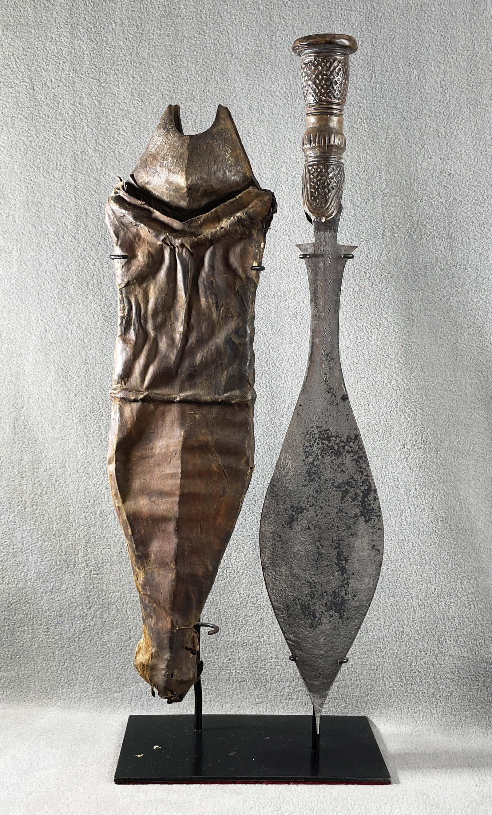 African Congo Wongo Court Sword & Scabbard Display: Country of Origin: Presently Democratic Republic of the Congo (DRC); originates from the era of the Belgium Congo (1908-1960) Early 20th Century Wongo court sword & scabbard. Hand-forged metal blade w