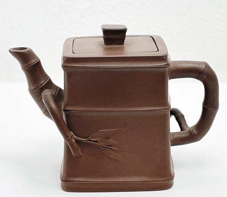 Chinese Yixing Clay Teapot Bamboo: Chinese Yixing clay teapot, rectangular in shape with bamboo detailing and protrusions. Light impressed marks on the undersides of pot & lid as seen. Dimensions: 5”W x 3.25”T x 2”D