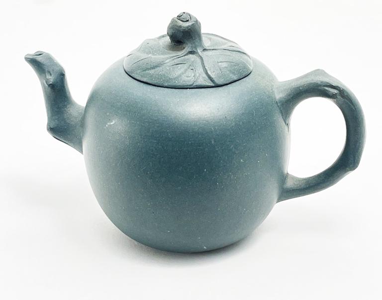 Small Chinese Yixing Clay Teapot: Small Chinese Yixing clay teapot with a circular shape and branch motif handle, lid and spout. Impressed marks on the undersides of pot & lid as seen. Appears to be a tiny chip on end of spout. Dimens