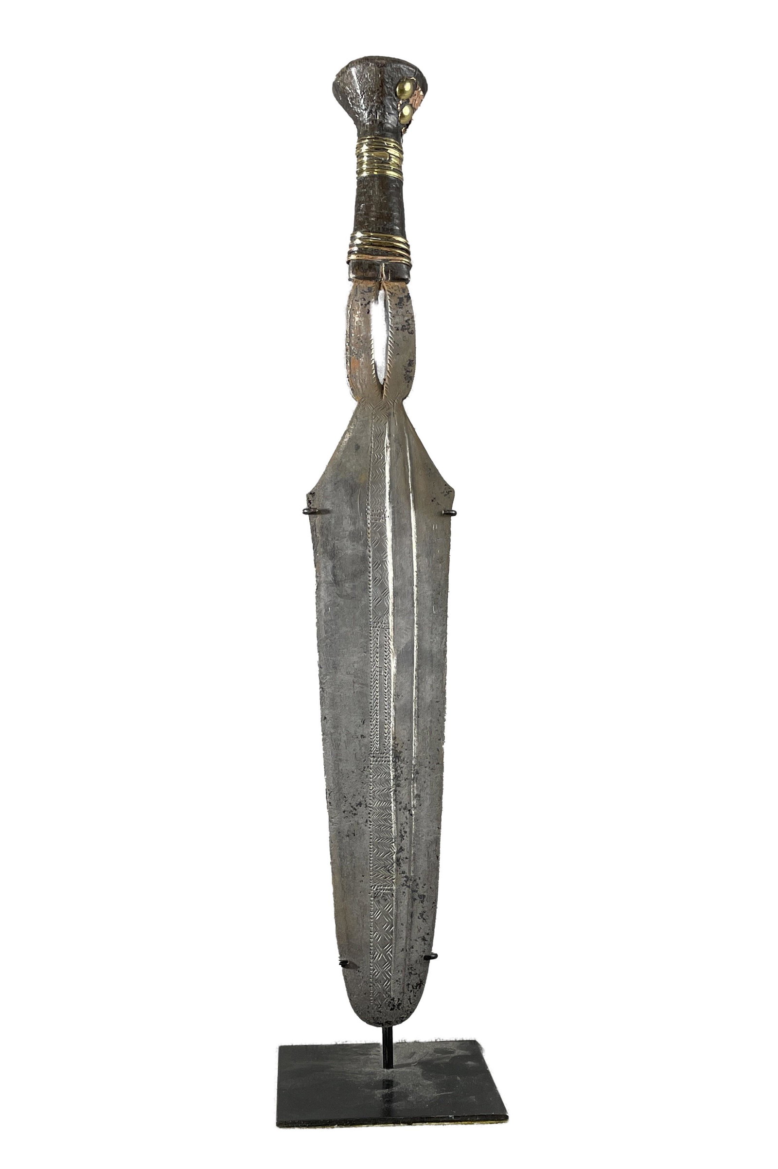 African Congo Ngombe Short Sword Display Included: Country of Origin: Presently Democratic Republic of the Congo (DRC); originates from the era of the Belgium Congo (1908-1960) Early 20th Century Ngombe short sword. Hand-forged metal blade with decora