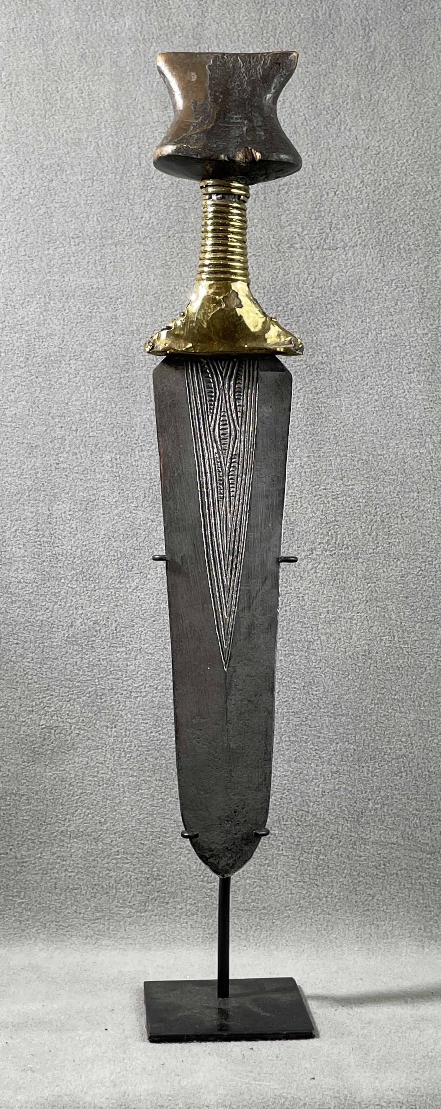 African Congo Knife Display Included: Country of Origin: Presently Democratic Republic of the Congo (DRC); originates from the era of the Belgium Congo (1908-1960) Early 20th Century court sword. Hand-forged metal blade with incised detai