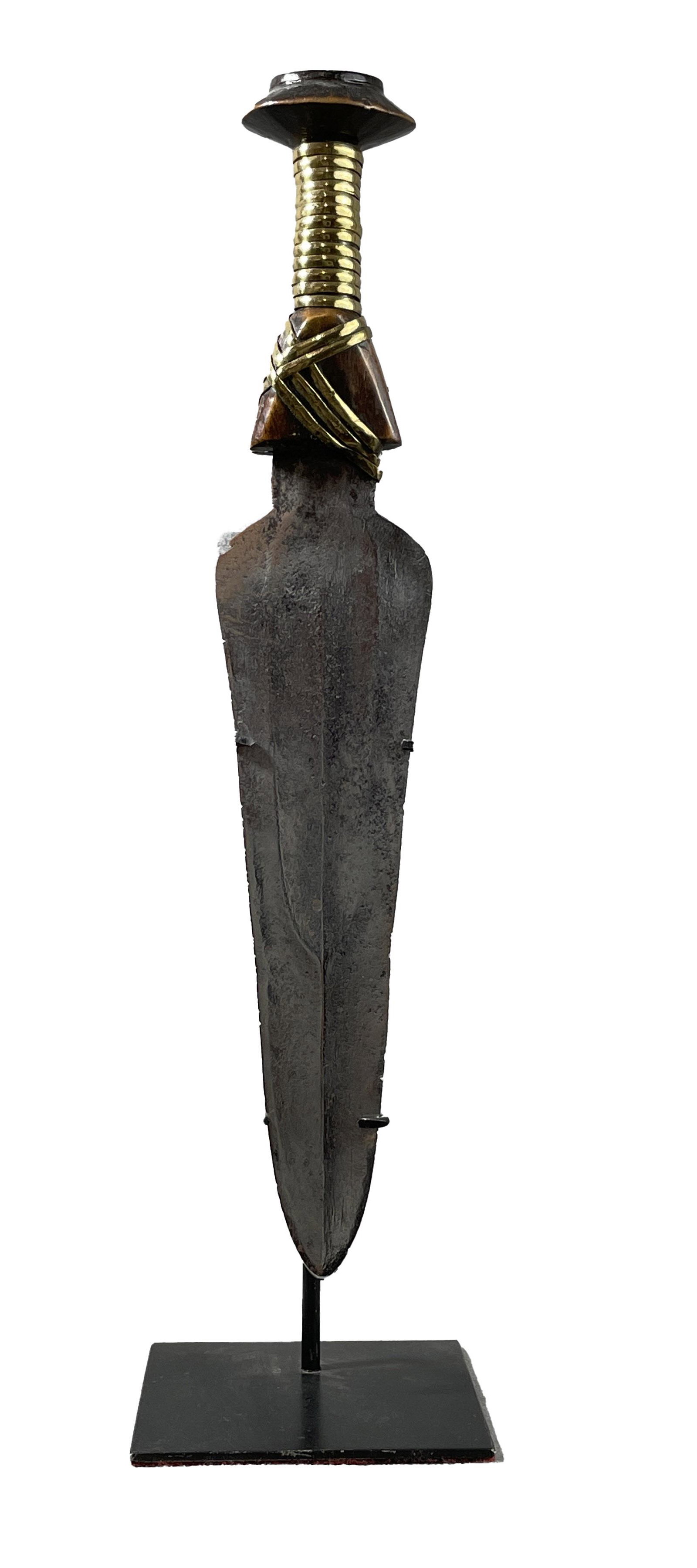 African Congo Knife Display Included: Country of Origin: Presently Democratic Republic of the Congo (DRC); originates from the era of the Belgium Congo (1908-1960) Early 20th Century court sword. Hand-forged metal blade with wooden handle