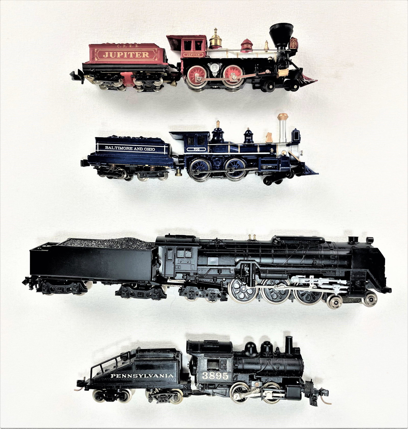 Group N Steam Locomotive Train Sets: Group of four (4) N scale locomotive steam engines and tenders including Bachmann #703, Kato #203, Bachmann The Jupiter, and Atlas 3895. Not tested. All appear in good condition. See photos for condit