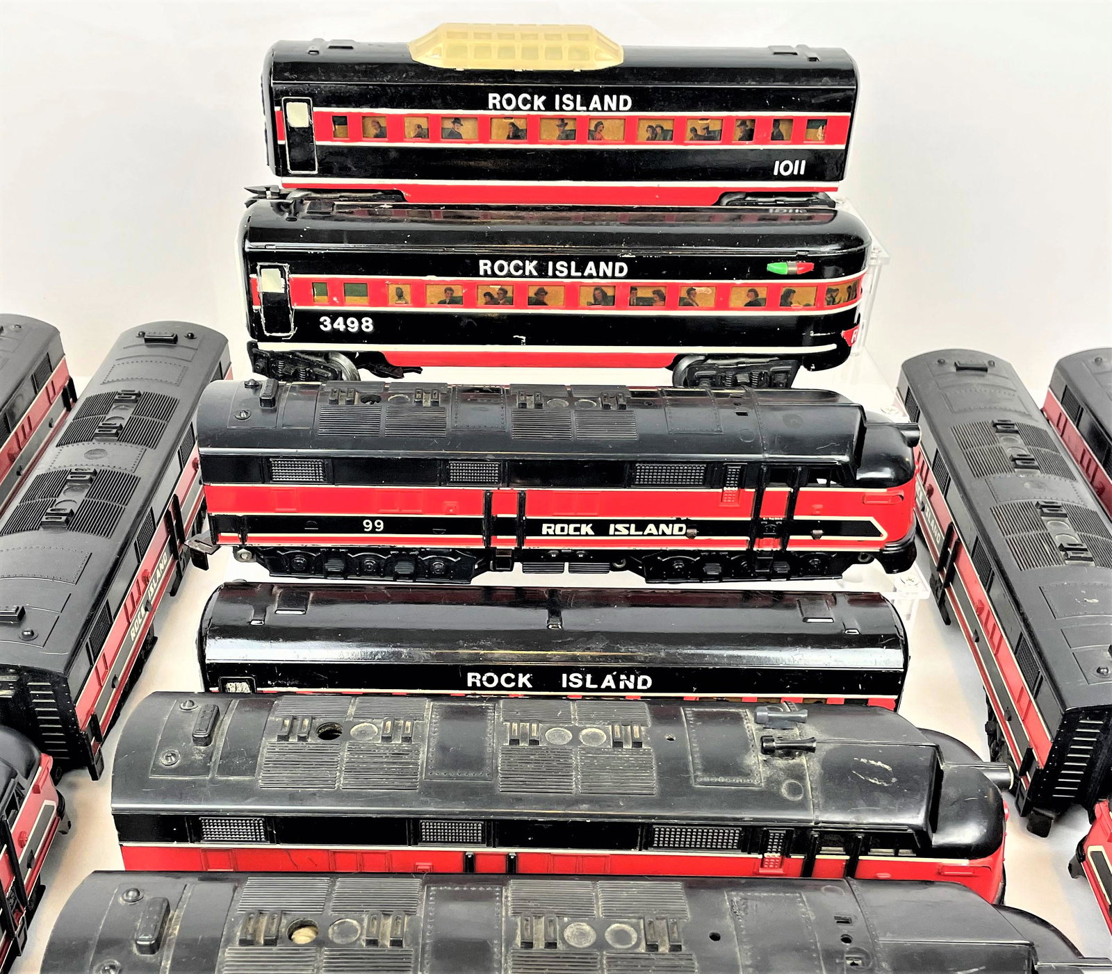 Large Group Marx Rock Island Engines & Train Cars: Large Group of vintage Marx Rock Island O scale train locomotives including two sets of 99 engines and dummy engines, an additional 99 engine, and eight passenger/observation cars including 3498, 1011