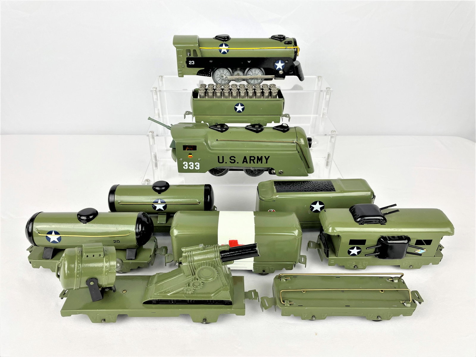 Marx Customized US Army Supply Train Set: Marx vintage US Army Supply Train including two engines, two tankers, two box cars, three flatbeds with guns, ammo, and a spotlight, and a caboose. Trains have been "customized" with overpainting and 