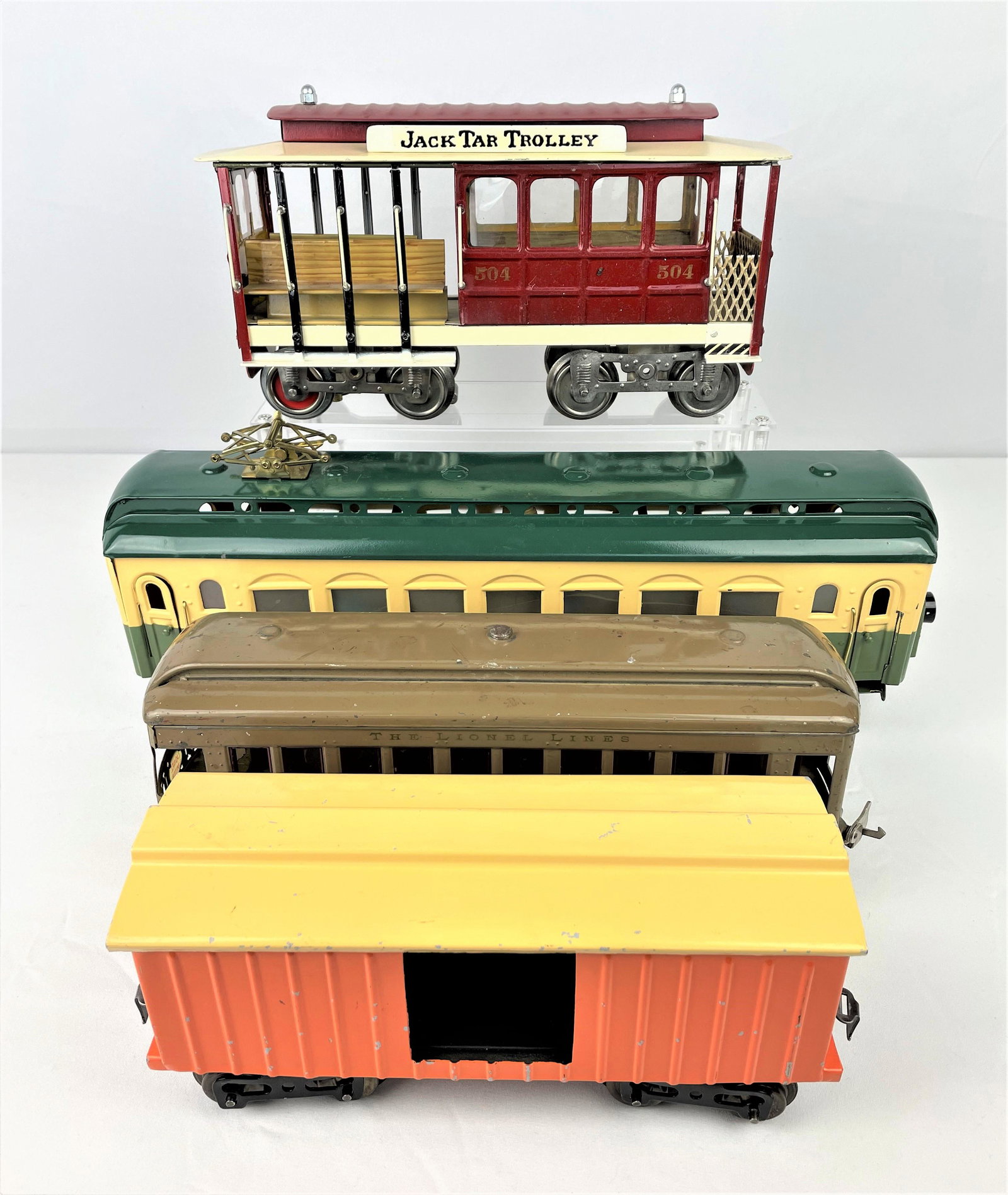 Four Large G and Standard Gauge Train Cars: Four large G scale and Standard gauge train cars including a vintage Lionel #338 olive colored observation car, a vintage Lionel orange colored box car, an unidentified electric yellow and green obser