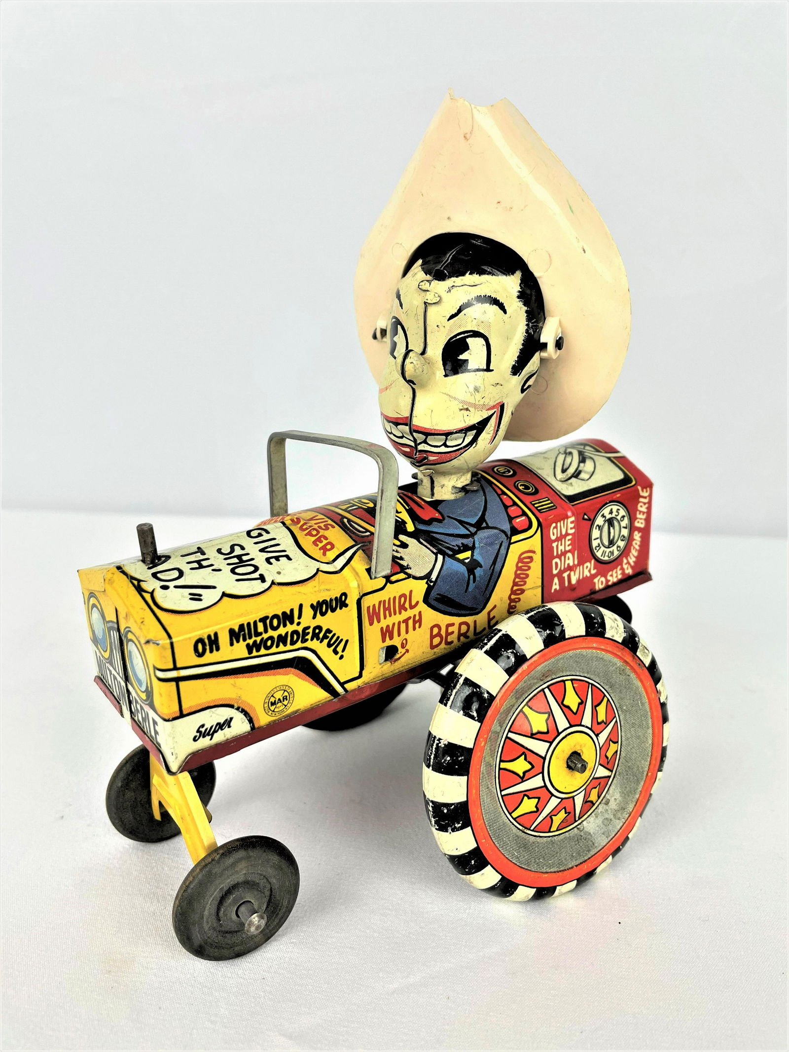 Marx 1950s Milton Berle Wind-Up Toy: Vintage 1950s Marx tin litho wind-up toy featuring Milton Berle with a cowboy hat driving a tractor. Wear/marks to surface as seen.See photos for condition details. Wind-up mechanism appears to need s