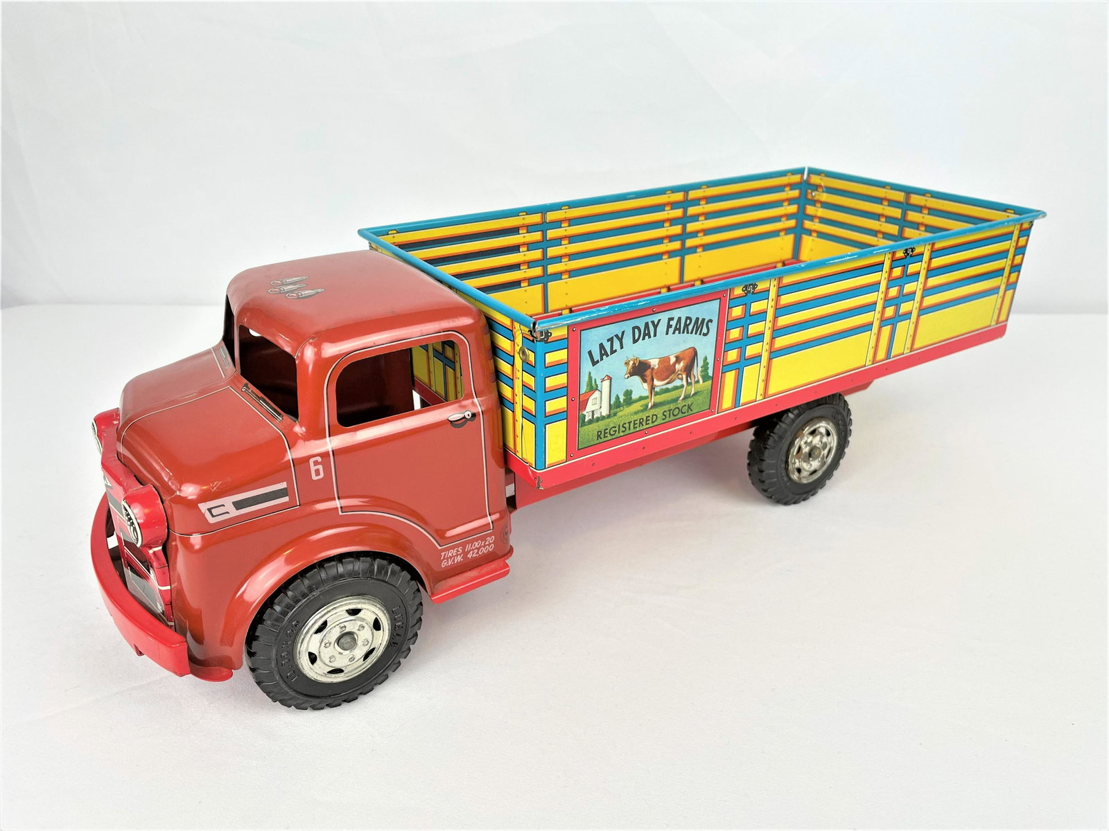 1950s Marx Tin Litho Lazy Day Farms Truck: Vintage 1950s Marx tin litho Lazy Day Farms stake body truck. Very good condition; paint is bright with only minor wear. Light rusting on one hub cap. See photos for condition details. 17.75" long