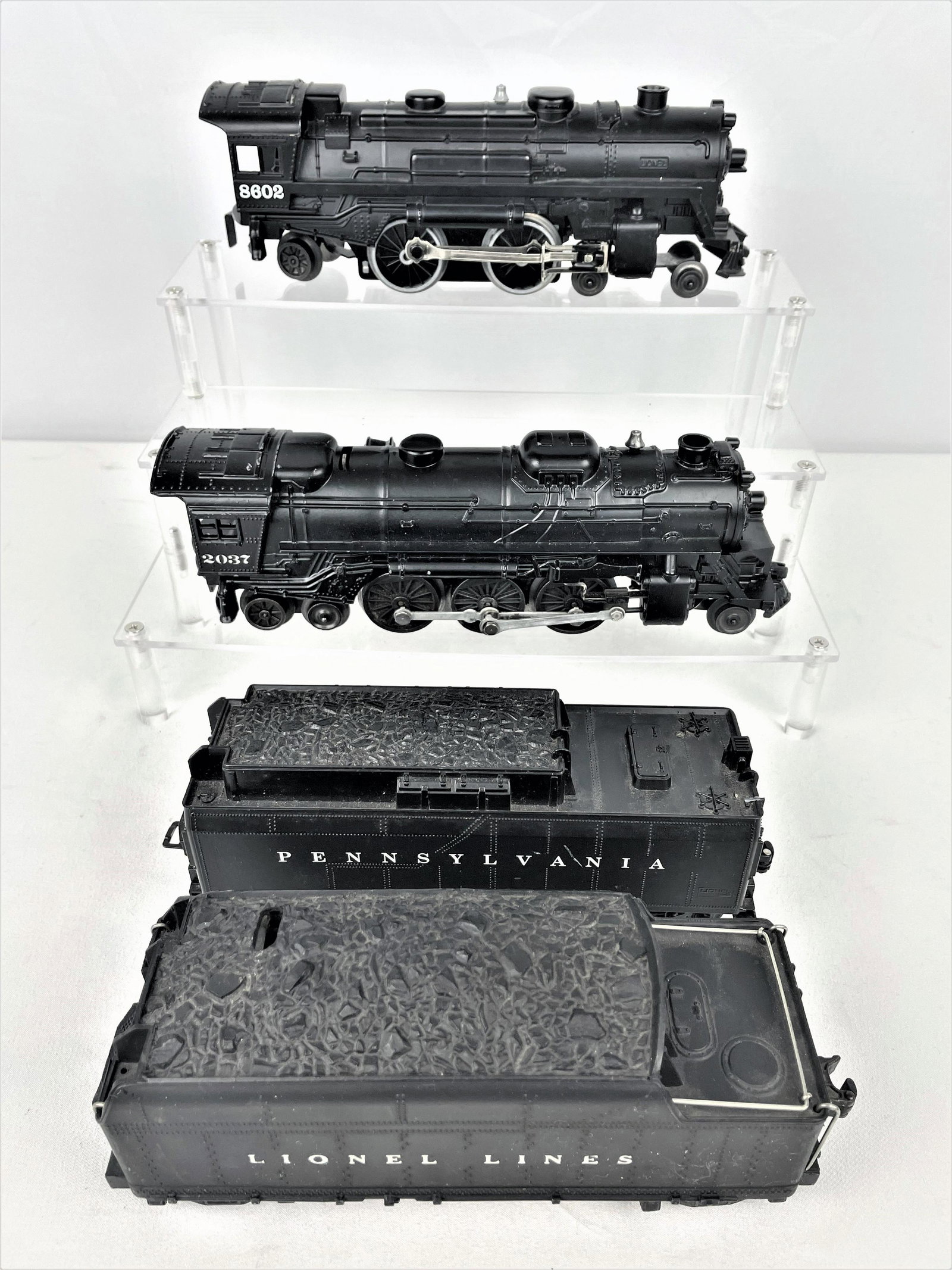 Two Lionel Engines & Tenders 8602 & 2037: Two Lionel O scale engines including 8602 & 2037. Tenders may not be original to set. Untested. Lighter vintage wear. See photos for condition details.