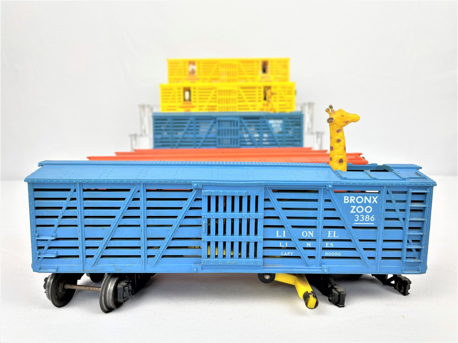 Group Lionel Animal Transport Cars: Group of seven (7) Lionel animal transport cars including two 3386 Bronx Zoo, two 6473 Horse Transport cars, and three 3656 cattle cars. Vintage wear. See photos for condition details.