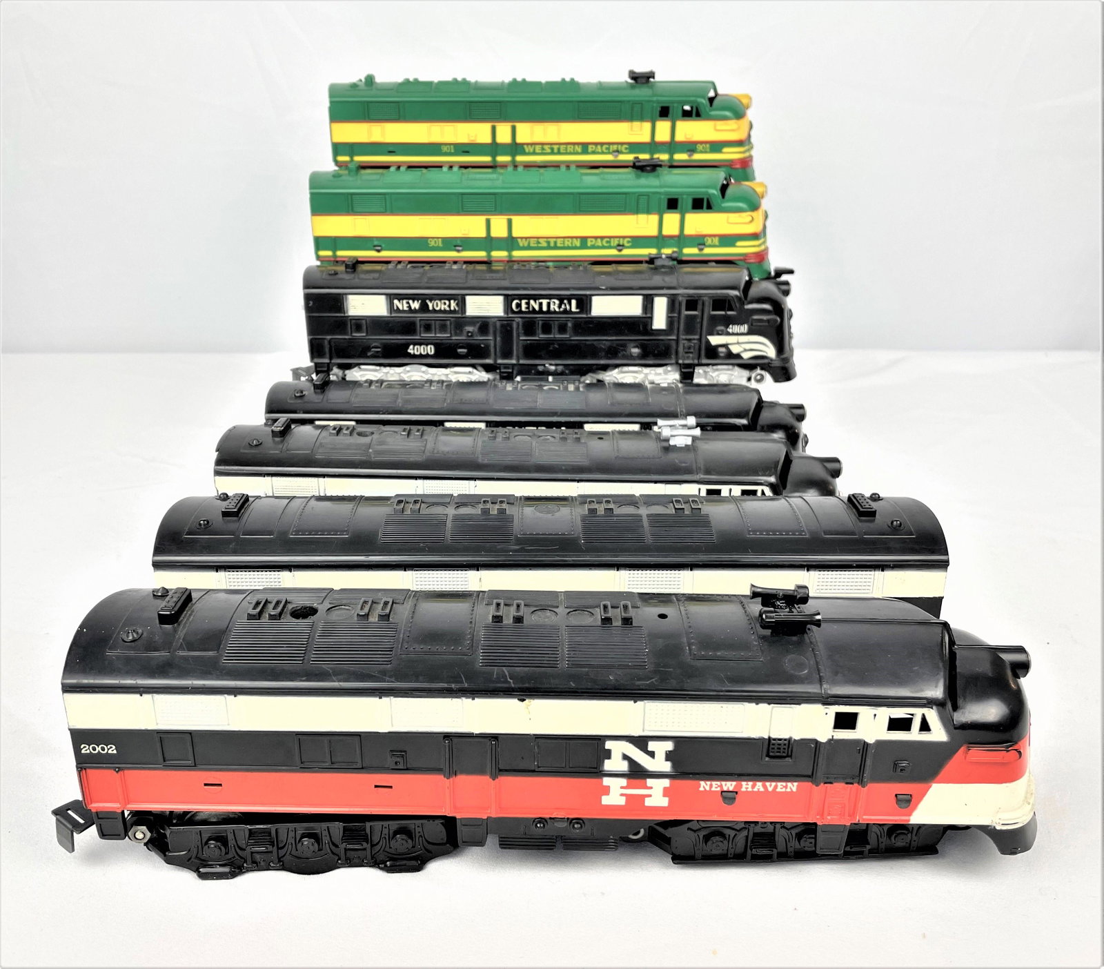 Three Sets Marx Diesel Engines & Trains: Three sets (7 pieces total) of vintage Marx diesel locomotives including a New York Central 4000 engine and dummy engine, a three piece New Haven set with engine, dummy engine and passenger car, and a