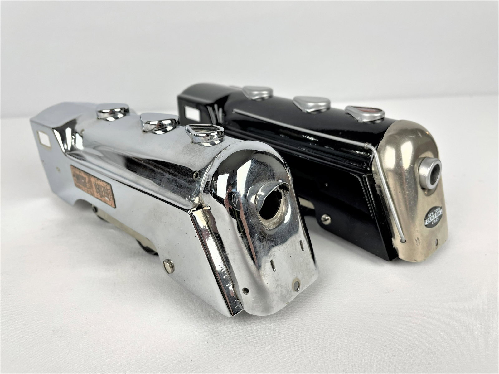 Marx Prewar Commodore Vanderbilt Engines: Two (2) Marx Prewar Commodore Vanderbilt O scale train locomotive engines, one black and one rarer steel colored. Untested. Vintage wear throughout including some pitting on steel engine as seen. See 