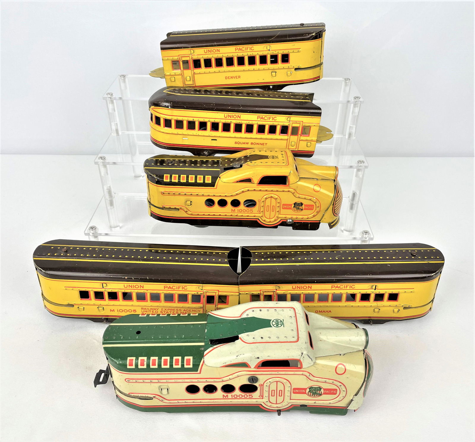 Marx Union Pacific Freight Train Set: Vintage Marx O scale tin litho Union Pacific wind-up freight set including two M10005 engines, and four cars matching the yellow engine. Vintage wear. There is a key attached to the yellow engine, but