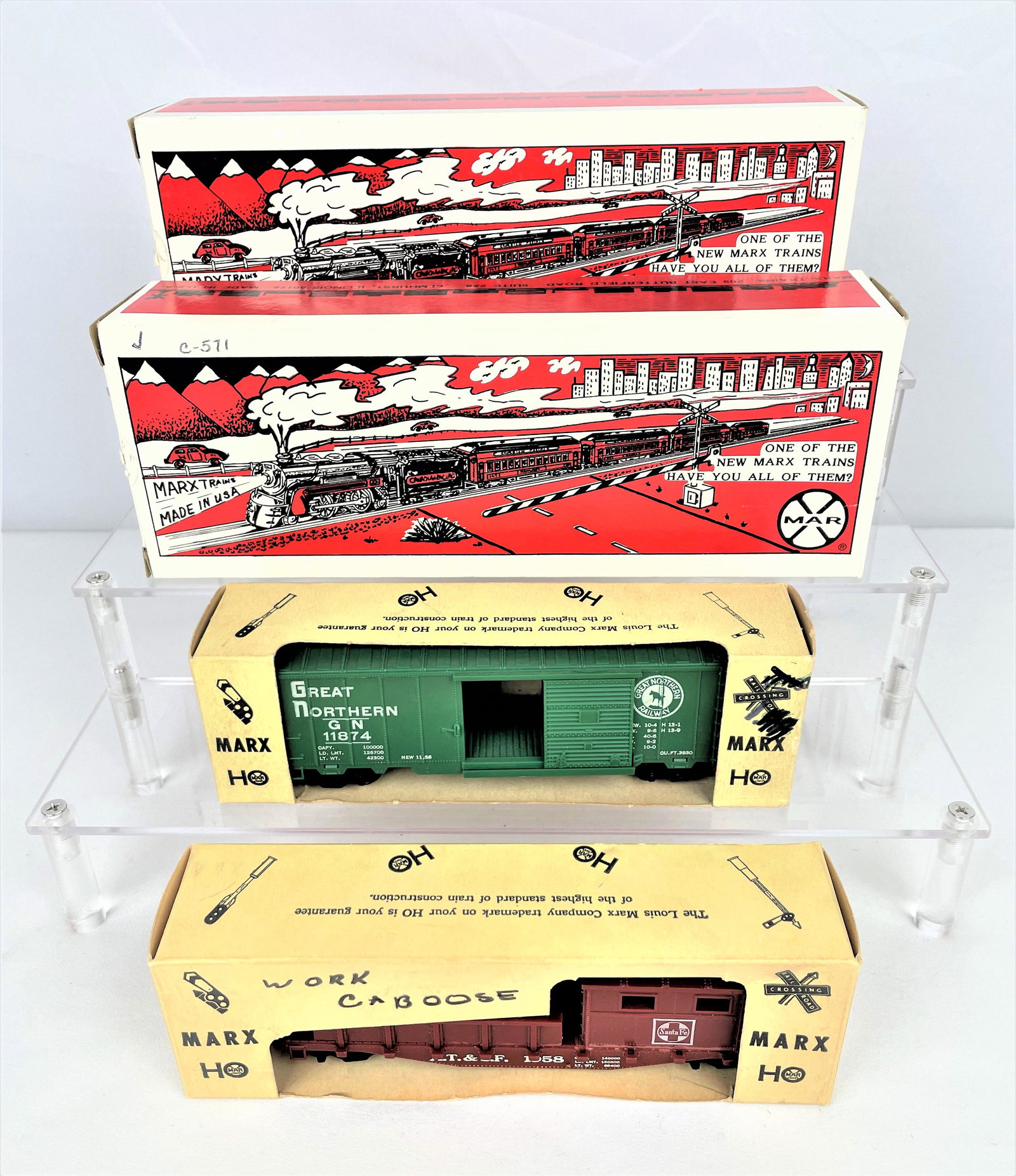 Group Modern Marx Train Cars: Group of four (4) Modern Marx train cars in their original boxes including 7352, 73418, 11874, and a 1958 work caboose. Appear unused. 11874 and the work caboose are in Christmas packaging. Wear and s