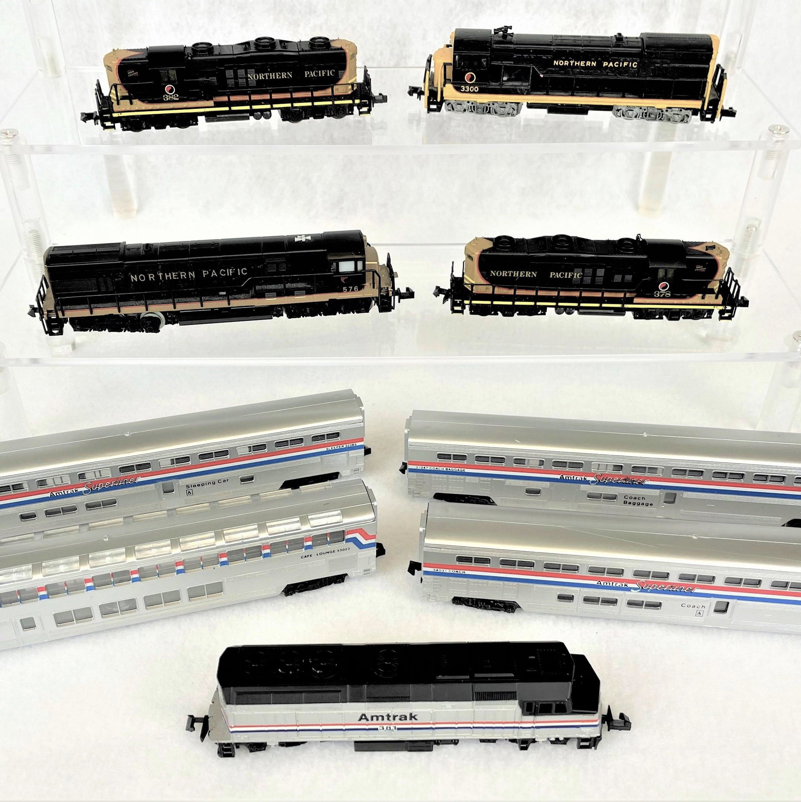 N Scale Diesel Engines & Life-Like Amtrak Set: Life-Like Amtrak set with diesel engine 381 and four observation cars and four Northern Pacific diesel engines including a Trix, Bachmann and two Life-Like versions. Untested. Light vintage wear. See
