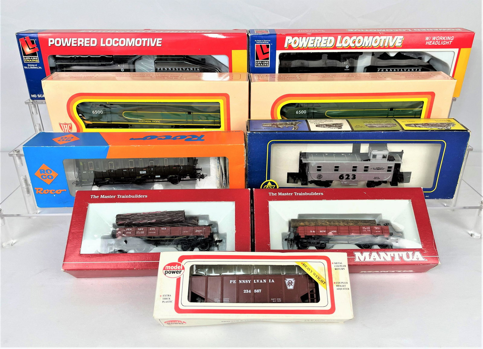 Group HO Train Cars Various Makers: Group of nine (9) HO scale train cars from various manufacters in their original boxes including Roco 44505, Life-Like 8344 & 433-8343, International Hobby Corp. M384 fM Diesel & M584 FM Diesel A Dumm