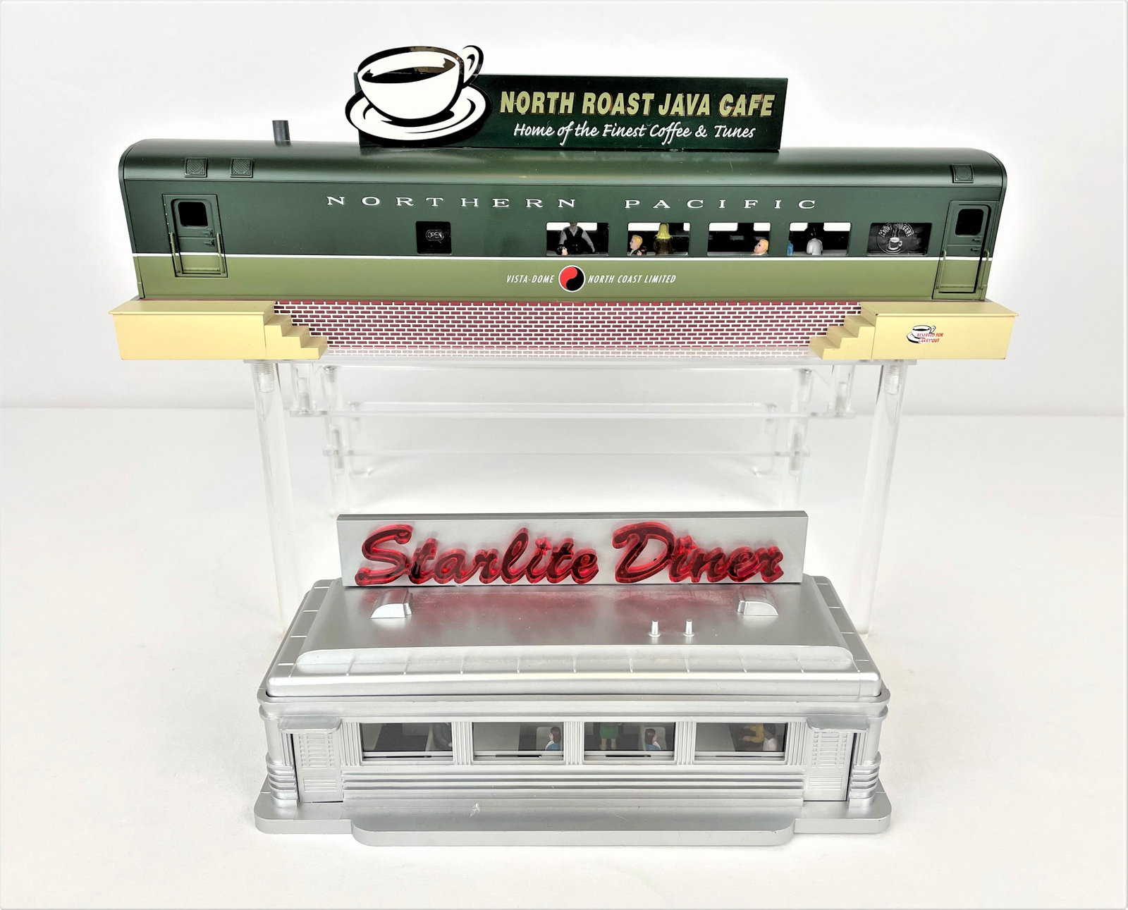 Two Dining Car Diorama Accessories: Two O scale railroad dining car accessory units including a Lionel smoking Northern Pacific Java diner and a K-Line Starlight Diner K-40816. Untested. Missing original parking lots. Very light wear.