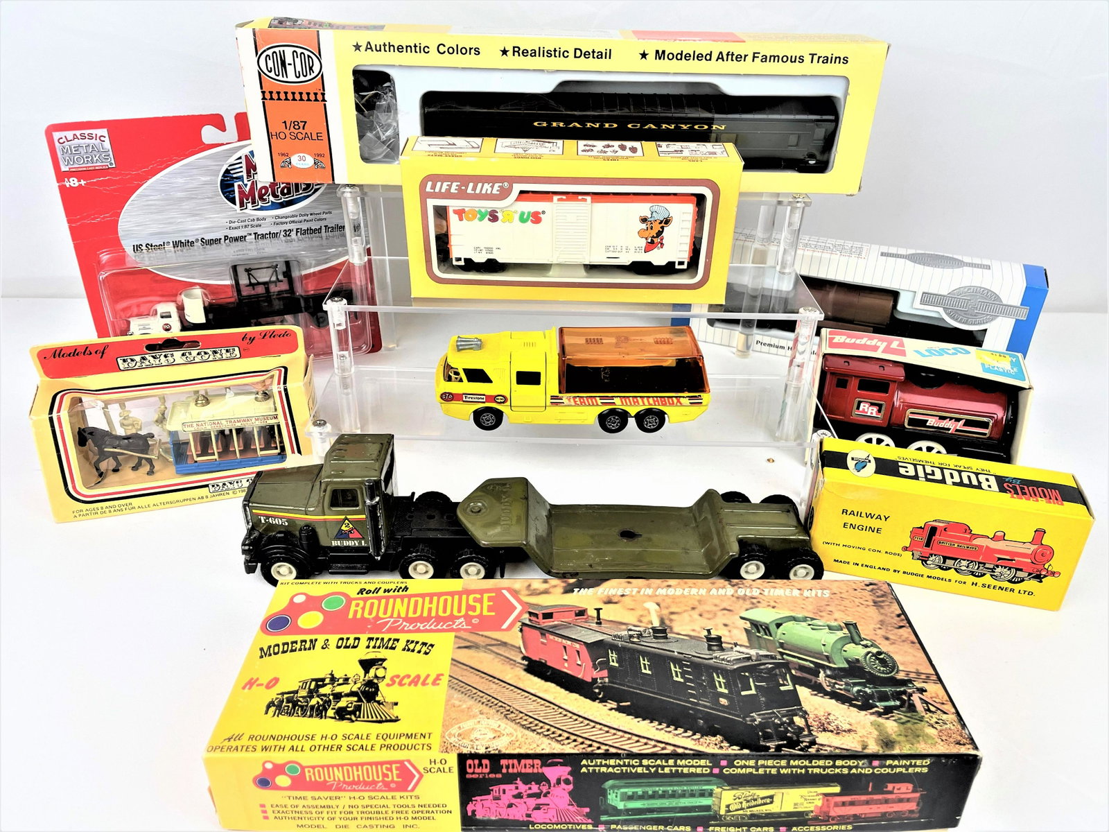 Group Toy Trains & Cars Various Makers: Group of eleven (11) toy trains and cars, most in their original boxes. Includes Bachmann, Con-Cor, Life-Like, Budgie, Buddy L, a Roundhouse train kit, and more as seen. Also includes a Buddy L transp