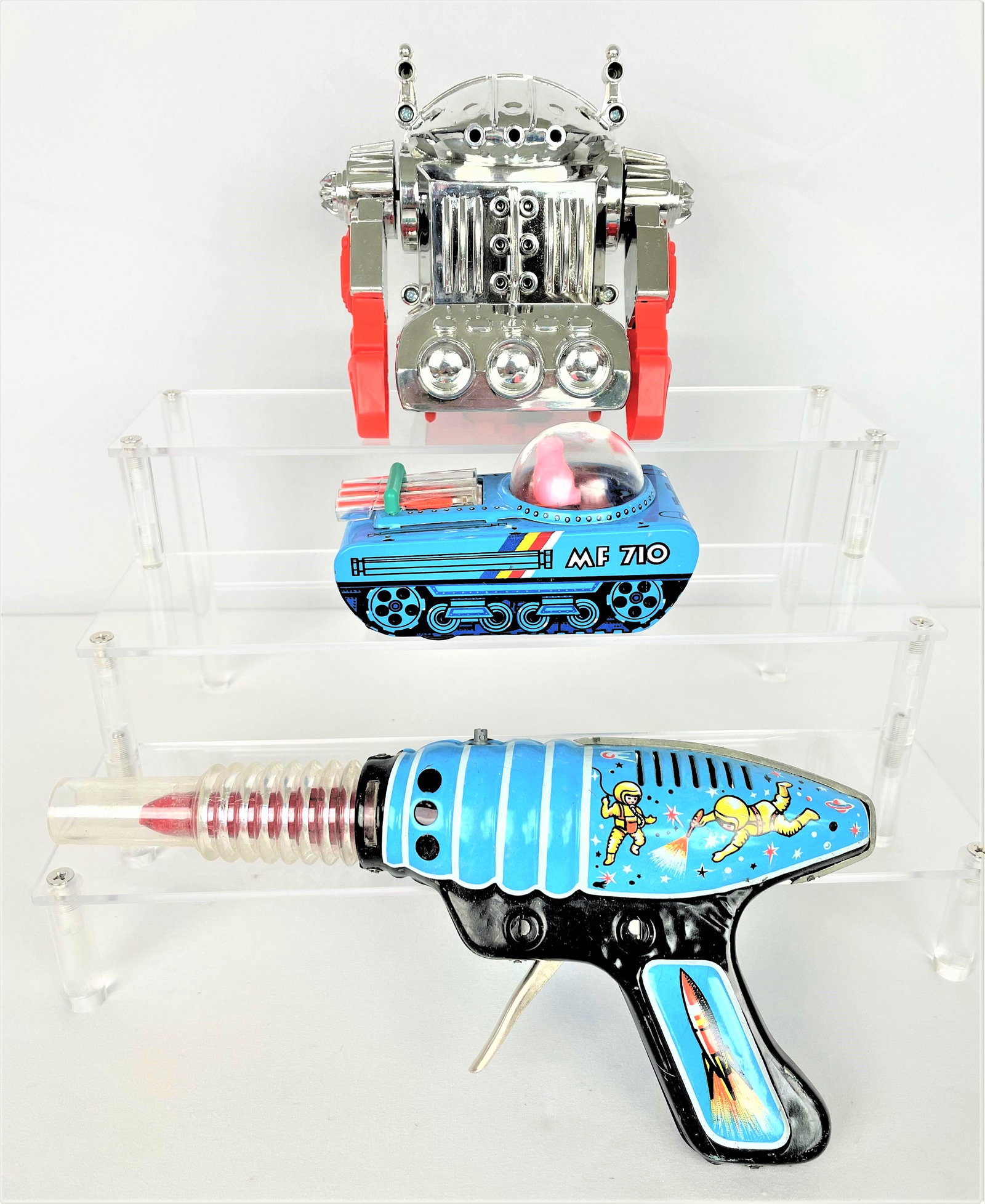 Space Tin Litho Toys Rocket Tank Robot: Three (3) later vintage tin litho space themed toys including Hungarian made Rocket Pistol (Raketapisztoly), Stars Landing MF 710 tank, and battery operated Acrobat Robot. All in original boxes. Pisto