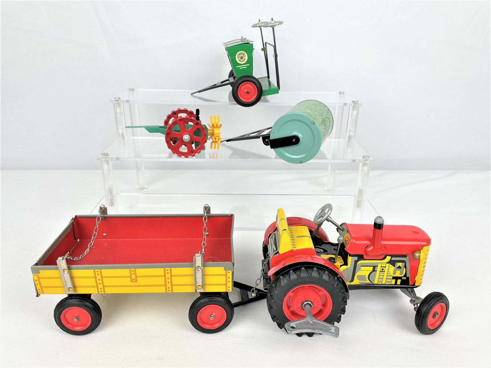 Group Kovap Czech Tractor & Accessories: Group of four (4) late vintage Kovap tin litho toys made in the Czech Republic including a tractor trailer, potato spinner, sowing machine, and roller. In original boxes. Toys in excellent shape, appe