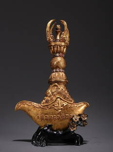 Gilt Bronze Gem Embedded Vajra: Gilt Bronze Gem Embedded Vajra Size: Height 23cm, Width 14.6cm, Thickness 4cm, Weight 830g All measurements are approximate