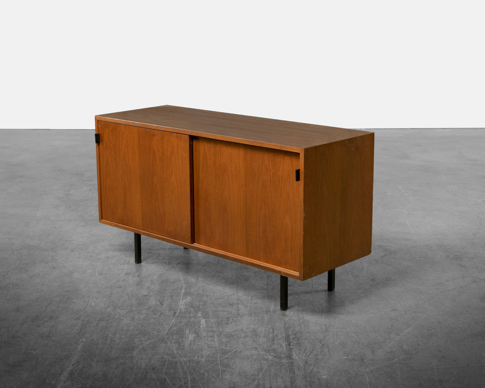 Florence Knoll - Credenza: A Florence Knoll laminate top credenza with leather pulls. Dimensions : 27.5" x 48" x 18"