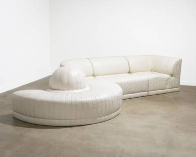 Roche Bobois - Leather Sectional Sofa: A four piece white leather sectional sofa by Roche Bobois with channeled stitching and crescent accent. Label on underside, circa 1985. . All measurements are in inches.